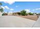 Exterior view of the property featuring a driveway, garage, and desert landscaping at 1213 W Esplanade St, Mesa, AZ 85201