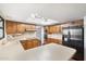 Bright kitchen with wooden cabinets, an island, and stainless steel refrigerator at 1213 W Esplanade St, Mesa, AZ 85201