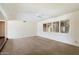 Inviting living room with neutral carpeting and a large window with shutter blinds at 1213 W Esplanade St, Mesa, AZ 85201