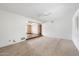 Bright living room featuring neutral carpeting, a ceiling fan, and white walls at 1213 W Esplanade St, Mesa, AZ 85201