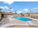 Backyard view of pool surrounded by mature landscaping and a yellow brick home at 1213 W Esplanade St, Mesa, AZ 85201