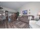 Comfortable living room with wood floors, a plush sofa, and natural light at 13423 W Countryside Dr, Sun City West, AZ 85375