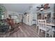 Spacious living room featuring wood flooring, built-in shelving and open access to dining area at 13423 W Countryside Dr, Sun City West, AZ 85375