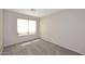 Cozy bedroom featuring plush carpeting, neutral walls, and a sunlit window at 13646 W Fargo Dr, Surprise, AZ 85374