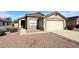 Charming single-level home with a two-car garage and low maintenance desert landscaping in front at 13646 W Fargo Dr, Surprise, AZ 85374