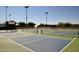 Several pickleball courts with new style paint and tall net fencing in a well maintained park at 13646 W Fargo Dr, Surprise, AZ 85374