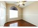 This bedroom has hardwood floors, a ceiling fan, and modern window coverings at 1406 W Charleston Ave, Phoenix, AZ 85023