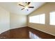 This bedroom has hardwood floors, a ceiling fan, lots of light, and neutral paint at 1406 W Charleston Ave, Phoenix, AZ 85023