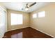 Cozy bedroom features hardwood floors, a ceiling fan, and a double window at 1406 W Charleston Ave, Phoenix, AZ 85023