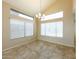 Dining room featuring tile floors, modern chandelier, and large windows providing ample natural light at 1406 W Charleston Ave, Phoenix, AZ 85023