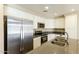 Modern kitchen showcasing white cabinetry, stainless steel appliances, granite countertops, and ample lighting at 1406 W Charleston Ave, Phoenix, AZ 85023