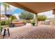 Lush backyard features a built-in spa, potted plants, and covered patio area at 14686 W Clarendon Ave, Goodyear, AZ 85395