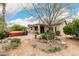 Backyard featuring a paver patio, in-ground spa, plants, bushes, and a large shade tree at 14686 W Clarendon Ave, Goodyear, AZ 85395