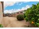 Backyard area with mature landscaping, a seating area, and block wall providing privacy at 14686 W Clarendon Ave, Goodyear, AZ 85395