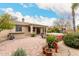 Paver patio featuring a raised spa area and a covered patio, surrounded by lush landscaping at 14686 W Clarendon Ave, Goodyear, AZ 85395