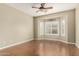 Bedroom featuring wood floors, bay windows with shutters, and neutral color at 14686 W Clarendon Ave, Goodyear, AZ 85395