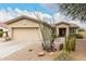 Charming single-story home with desert landscaping, mature trees, and a two-car garage at 14686 W Clarendon Ave, Goodyear, AZ 85395