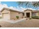 Single-story home featuring desert landscaping, flower pots, and walkway to front door at 14686 W Clarendon Ave, Goodyear, AZ 85395