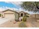 Charming single-story home with desert landscaping, mature trees, and a two-car garage at 14686 W Clarendon Ave, Goodyear, AZ 85395