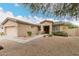 Single-story home featuring desert landscaping, flower pots, and walkway to front door at 14686 W Clarendon Ave, Goodyear, AZ 85395