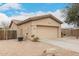 Single-story home featuring a two-car garage and desert landscape at 14686 W Clarendon Ave, Goodyear, AZ 85395