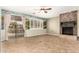 Cozy living area featuring a fireplace and sliding glass doors to the patio at 14686 W Clarendon Ave, Goodyear, AZ 85395