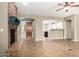 Inviting living room with brick fireplace, tile floors, and an open layout to the kitchen at 14686 W Clarendon Ave, Goodyear, AZ 85395