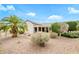 Beautiful backyard showcasing a covered patio, mature landscaping, and desert-style yard at 15750 W Linksview Dr, Surprise, AZ 85374