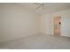 Serene bedroom with neutral carpet and a view of an en-suite bathroom at 15750 W Linksview Dr, Surprise, AZ 85374