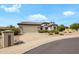 Charming single-story home with a well-maintained yard, showcasing a spacious driveway and a two-car garage at 15750 W Linksview Dr, Surprise, AZ 85374