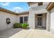 Charming courtyard entrance featuring desert landscaping, mature plants and a secure front door at 15750 W Linksview Dr, Surprise, AZ 85374