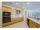 Open kitchen with custom cabinetry, stainless steel appliances and eat in bar at 15750 W Linksview Dr, Surprise, AZ 85374