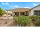 Inviting covered patio with desert landscaping and comfortable seating, perfect for outdoor living at 15750 W Linksview Dr, Surprise, AZ 85374