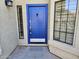 Eye-catching blue front door with sidelight window, covered entrance, and neutral stucco exterior at 1635 W Wisteria Dr, Chandler, AZ 85248