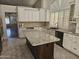 The spacious kitchen boasts custom cabinets, granite counters, an island, and stainless steel appliances at 1635 W Wisteria Dr, Chandler, AZ 85248