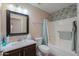 Well-lit bathroom features a vanity, toilet, and shower with decorative tile accents at 1814 N Parkside Ln, Casa Grande, AZ 85122