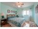 Bright bedroom with a decorative bedspread, ceiling fan, and natural light from the window at 1814 N Parkside Ln, Casa Grande, AZ 85122