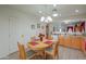 Cozy dining area features an oval table, pendant lighting and tile flooring with kitchen access at 1814 N Parkside Ln, Casa Grande, AZ 85122