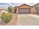 Charming home featuring low-maintenance desert landscaping and a spacious driveway leading to a two-car garage at 1814 N Parkside Ln, Casa Grande, AZ 85122