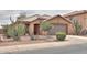 Charming single-story home with desert landscaping, enhancing curb appeal, and a two-car garage at 1814 N Parkside Ln, Casa Grande, AZ 85122