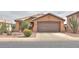 Inviting single-story home with a well-manicured desert landscaped front yard and a two-car garage at 1814 N Parkside Ln, Casa Grande, AZ 85122