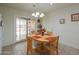 Functional kitchen with a dining table, sliding glass doors, and tile floors for easy maintenance at 1814 N Parkside Ln, Casa Grande, AZ 85122