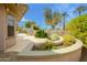 Landscaped backyard with beautiful mature landscaping, hardscape and a fountain feature at 20562 N Bear Canyon Ct, Surprise, AZ 85387