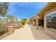 Beautiful water feature, landscaping and covered patio enhance this desert backyard at 20562 N Bear Canyon Ct, Surprise, AZ 85387