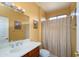 Cozy bathroom with a classic vanity, framed art, and a neutral shower curtain at 20562 N Bear Canyon Ct, Surprise, AZ 85387