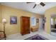 Bright bedroom showcasing a classic armoire, a decorative rug, and access to the hallway at 20562 N Bear Canyon Ct, Surprise, AZ 85387