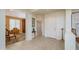 Bright foyer featuring neutral tile flooring, a white front door, and seamless access to living spaces at 20562 N Bear Canyon Ct, Surprise, AZ 85387