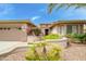 Inviting front entrance featuring a paver walkway and lush desert landscaping and covered entry at 20562 N Bear Canyon Ct, Surprise, AZ 85387