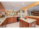 Kitchen with granite countertops, wooden cabinets and breakfast bar that adjoins dining area at 20562 N Bear Canyon Ct, Surprise, AZ 85387