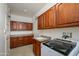 Spacious laundry room with ample cabinetry, a utility sink, and modern washer and dryer at 20562 N Bear Canyon Ct, Surprise, AZ 85387